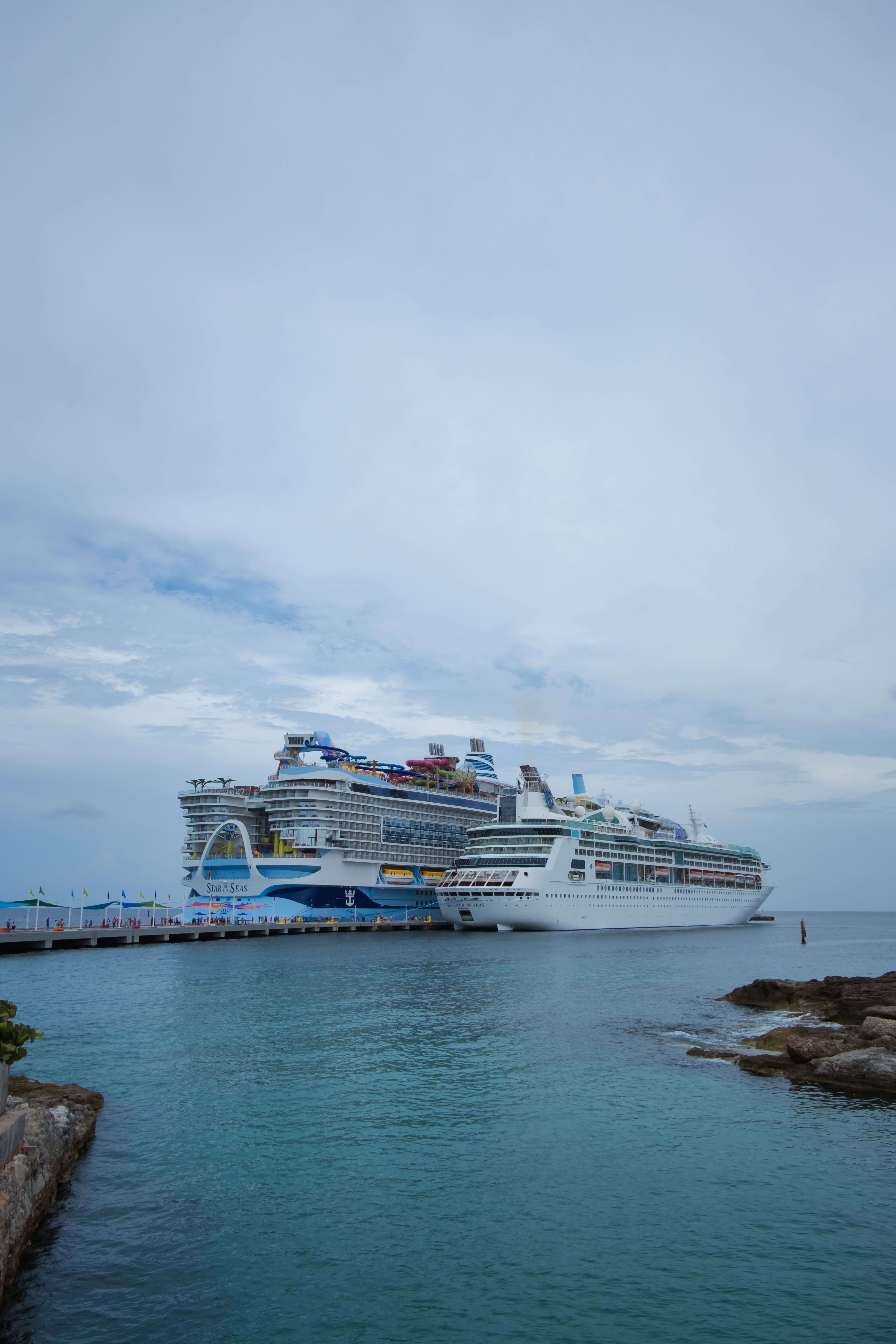 Two cruise ships from different cruise lines in port.